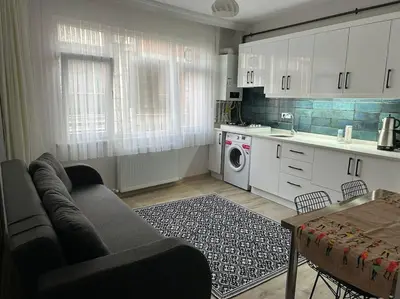 a living room with a couch and a kitchen at Üsküdar - Venüs home - Sakin Konaklama in Istanbul