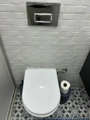 a white toilet in a bathroom with a roll of toilet paper at Üsküdar - Venüs home - Sakin Konaklama in Istanbul