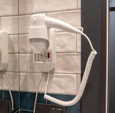 a phone hanging on a wall in a bathroom at Şişli Family Time Suites in Istanbul