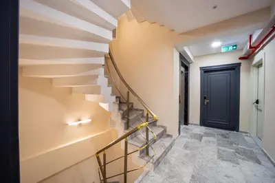 a staircase in a building with a black door at Şişli Family Time Suites in Istanbul