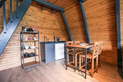 a kitchen with a table and chairs in a room at Happy Enjoy Bungalow in Sapanca