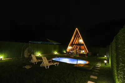 a small house with a swimming pool at night at Happy Enjoy Bungalow in Sapanca