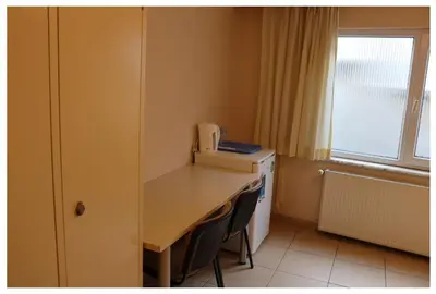 a small room with a desk and a window at Hostelist in Istanbul