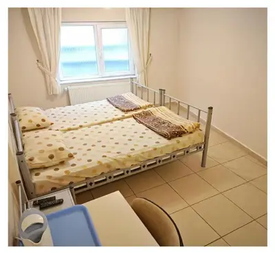 two beds in a room with a window at Hostelist in Istanbul