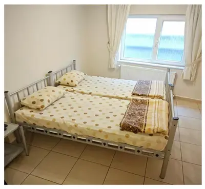 two beds in a bedroom with a window at Hostelist in Istanbul