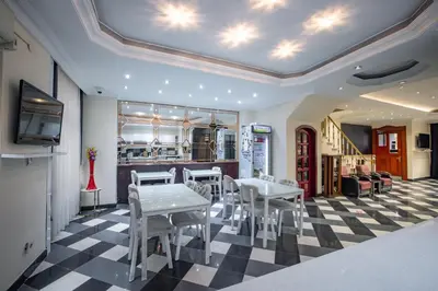 a dining room with tables and chairs on a checkered floor at Hotel Flash in Istanbul