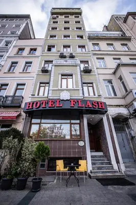 a hotel has a sign on the front of a building at Hotel Flash in Istanbul