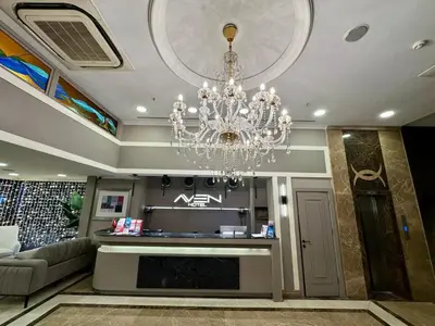 a living room with a chandelier hanging from the ceiling at Aven Hotel in Istanbul
