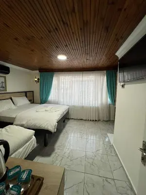 a bedroom with two beds and a wooden ceiling at Sultanahmet Sefa Hotel in Istanbul