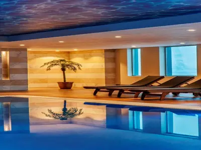 a swimming pool with a palm tree in a house at Kaya İstanbul Fair & Convention in Istanbul
