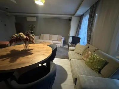 a living room with a table and a couch at Modern Suites Galata in Istanbul