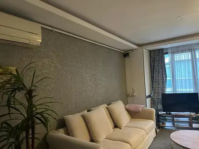 a living room with a couch and a flat screen tv at Modern Suites Galata in Istanbul
