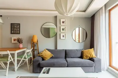 a living room with a blue couch and a table at Modern Suites Galata in Istanbul