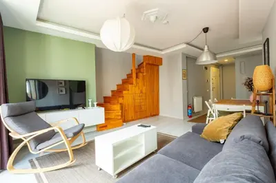a living room with a blue couch and a tv at Modern Suites Galata in Istanbul