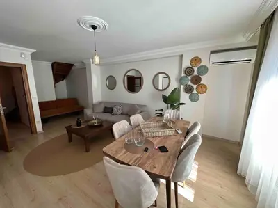 a living room with a table and a couch at Dublex roof top with AC, perfect location in Istanbul