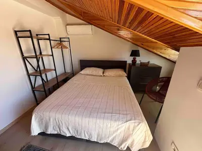 a bedroom with a large bed with a wooden ceiling at Dublex roof top with AC, perfect location in Istanbul