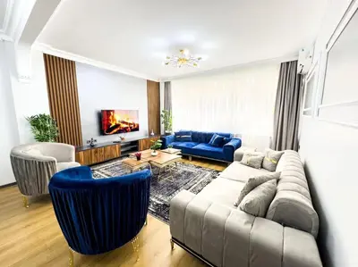 a living room with a couch and a blue sofa at شقه الأحلام بمنطقة شيشلى 341 in Istanbul