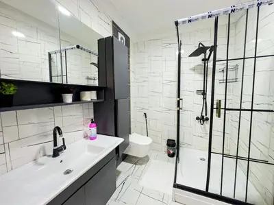 a white bathroom with a shower and a sink at شقه الأحلام بمنطقة شيشلى 341 in Istanbul