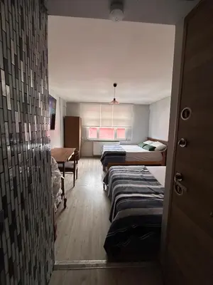 a room with four beds and a desk and a table at i1 House Hotel in Istanbul