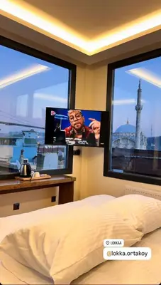 a bedroom with two large windows and two monitors at Lokka Hotel Ortakoy in Istanbul