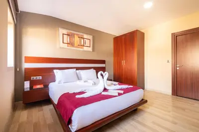 a bedroom with a bed with two swans on it at Park by Clover Nişantaşı Harbiye Şişli in Istanbul