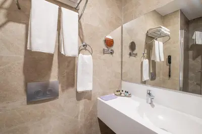 a bathroom with a sink and a mirror at Park by Clover Nişantaşı Harbiye Şişli in Istanbul