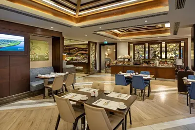 a restaurant with tables and chairs and a bar at Titanic City Taksim in Istanbul