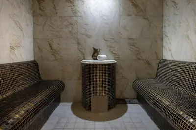 a room with two benches and a cat sitting on a table at Titanic City Taksim in Istanbul