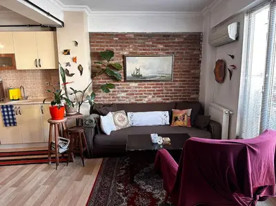a living room with a couch and a brick wall at Cozy Flat to Taxim, Beyoglu, Pera, Galata in Istanbul