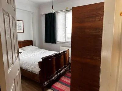 a bedroom with a bed and a large wooden door at Cozy Flat to Taxim, Beyoglu, Pera, Galata in Istanbul