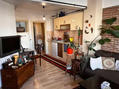 a living room with a couch and a kitchen at Cozy Flat to Taxim, Beyoglu, Pera, Galata in Istanbul