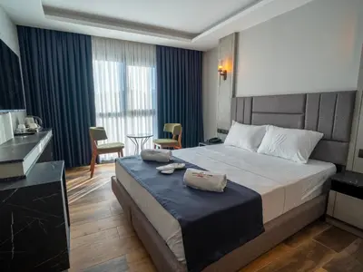 a hotel room with a bed and a table and chairs at Modernlux Hotel in Istanbul