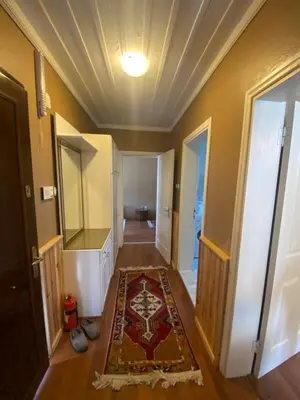 a hallway with a door and a rug on the floor at Serbesler Botanik, No 2 Mini House in Sakarya