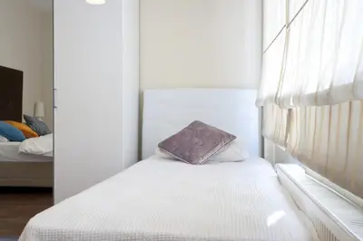 a small bedroom with a bed and a window at Spacious Balcony Suite Sultanahmet - Aslan Apartments in Istanbul