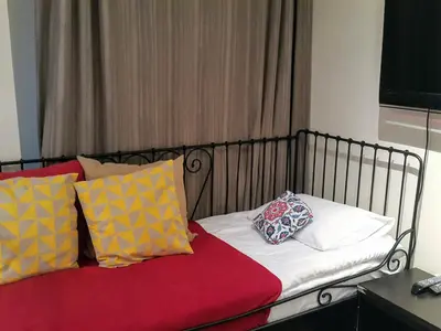 a bed with colorful pillows on it in a room at Spacious Balcony Suite Sultanahmet - Aslan Apartments in Istanbul