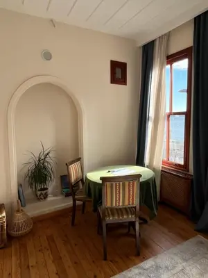 a room with a table and two chairs and a window at Levant Pension de Luxe in Istanbul