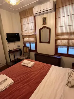 a bedroom with a bed with two towels on it at Levant Pension de Luxe in Istanbul