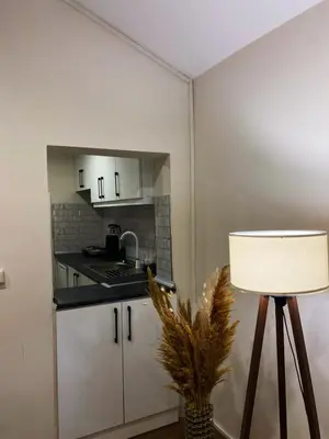 a small kitchen with a table and a lamp at Özkanlar in Istanbul
