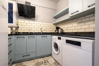 a white kitchen with a washing machine in it at Mayer Beyoglu Apartments in Istanbul
