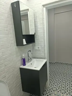 a bathroom with a sink and a mirror at Evinizin Konforunu Yaşayın ! in Istanbul