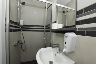 a bathroom with a sink and a shower and a mirror at Uzay Apartments in Istanbul