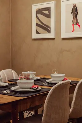 a wooden table with chairs and bowls and plates on it at Raya Suites in Istanbul