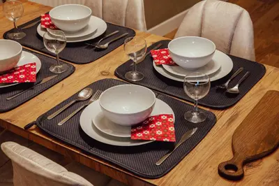 a table set with plates and bowls and wine glasses at Raya Suites in Istanbul