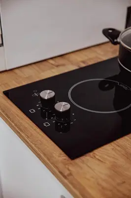 a black cutting board with two pots on a counter at Raya Suites in Istanbul