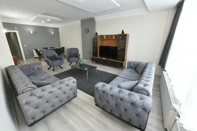 a living room with two couches and a television at Dogancay Suite in Istanbul