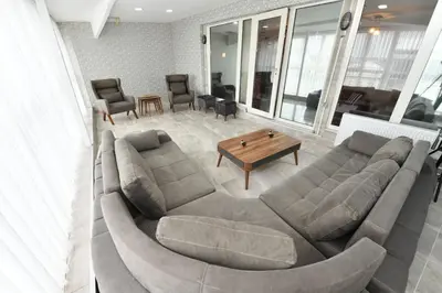 a living room with a large couch and a table at Dogancay Suite in Istanbul
