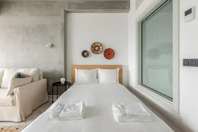 a bedroom with a large white bed and a couch at Cozy Bright Studio! ParkingGymPool Access! #374 in Istanbul