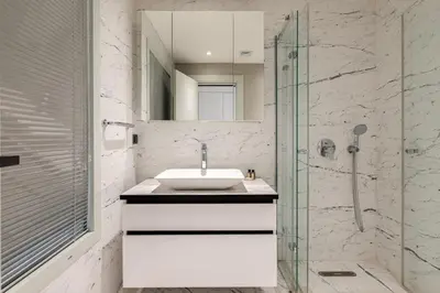 a bathroom with a sink and a glass shower at Cozy Bright Studio! ParkingGymPool Access! #374 in Istanbul