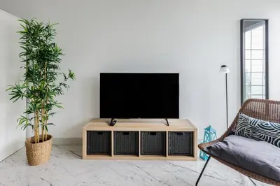 a living room with a flat screen tv on a table at Cozy Bright Studio! ParkingGymPool Access! #374 in Istanbul