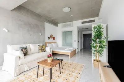 a living room with a white couch and a table at Cozy Bright Studio! ParkingGymPool Access! #374 in Istanbul